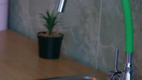 Close up view of a woman's hand putting water from the kitchen sink into the  스톡 동영상 129526257