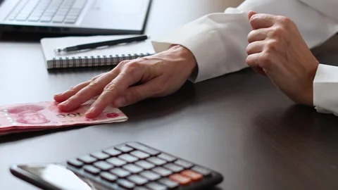 Close up view of womans hands and Chinese Yuan (CNY) banknotes. Stock Footage 307964168