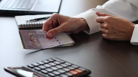 Close up view of woman's hands and Malaysian ringgit banknotes. Stock Footage 307964641