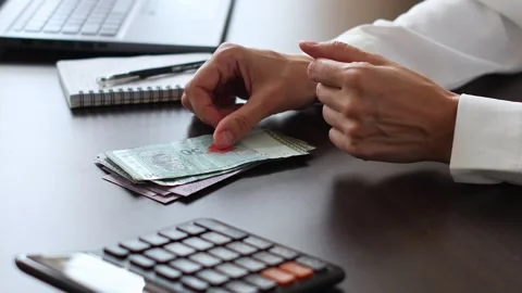 Close up view of womans hands and Malaysian ringgit banknotes. Stock Footage 307964886