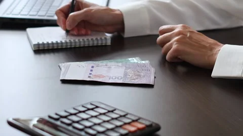 Close up view of womans hands and Malaysian ringgit banknotes. Stock Footage 307965027