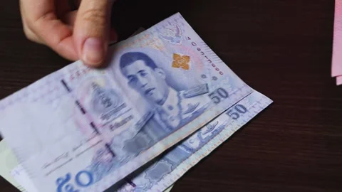 Close-up view of woman's hands count Thailand currency notes. Stock Footage 304090208