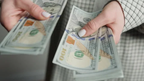 Close-up View of a Woman's Hands Counting American Hundred Dollar Bills Stock Footage 276175930