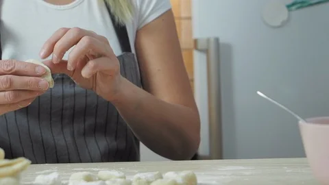 Close-up view of woman's hands with dough make ravioli Stock Footage 123444840