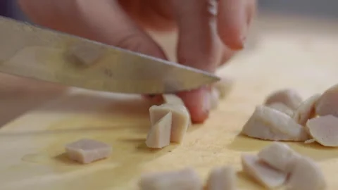 Close up view of Woman's hands slicing raw meatballs on a cutting board ove.. Stock Footage 329702965