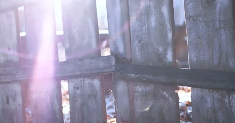 Close-Up View Of Wooden Fence Outside. Morning Sun Shining Through The Opening Video stock 59557265
