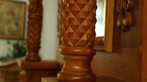 A close-up view of a wooden object placed on a shelf, possibly decorative or Stock Footage 311101171