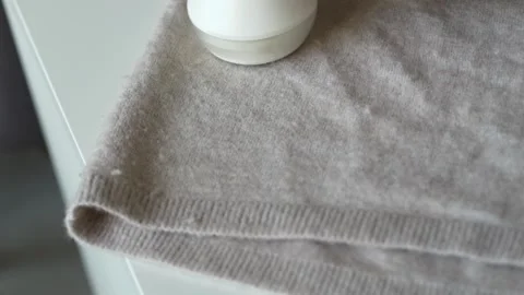 Close view of wool sweater texture during cleaning process. Fabric care routine Stock Footage 331864872