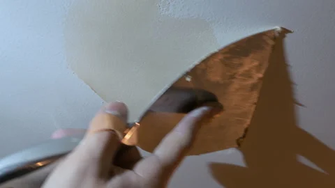 Close up view of Worker applying wall putty with a spatula to repair surface Stock Footage 332185811