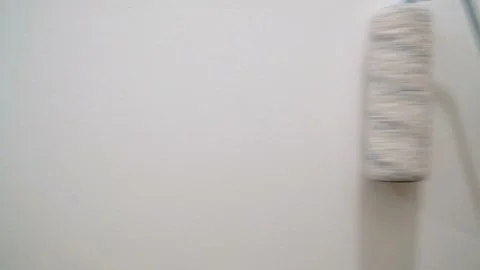 Close-up View of Worker Painter Paints the Wall with a Roller in Slow Motion Stock Footage 125713989