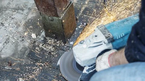 Close-up view of a worker working with angle grinder. Electric wheel grinding Stock Photos
