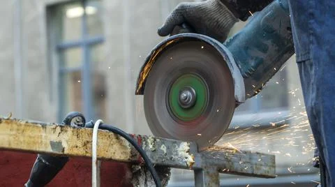 Close-up view of a worker working with angle grinder. Electric wheel grinding Stock Photos