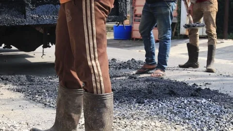 Close view on the workers and the asphalting machines Stock Footage 152008941