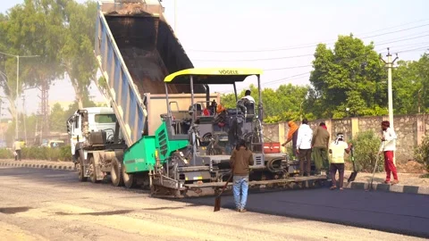 Close view on the workers and the asphalting machines Stock Footage 264550597