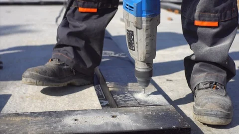 Close view: workers are using electric drill and screw gun. House constrtuction Video stock 118990758