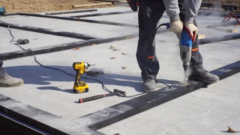 Close view: workers are using electric drill and screw gun. House constrtuction Video stock 119668798
