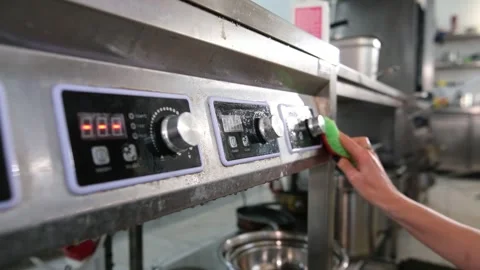 Close up view of a workers hand wiping down the control panel of a commercial Stock Footage 318317190