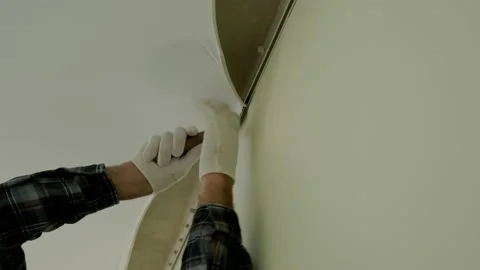 Close up view of Workers stretch the stretch ceiling in the room Stock Footage 167679482