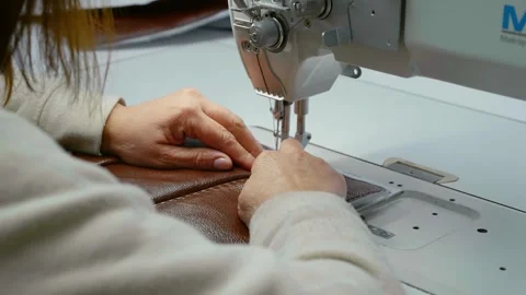 Close-up view of working sewing machine stitching leather. Stock Footage 296541796