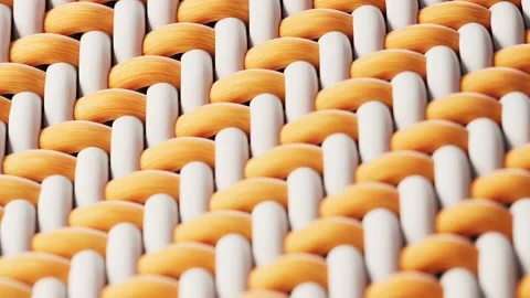 A close-up view of woven fabric with alternating white and orange threads, .. Stock Footage 332387681