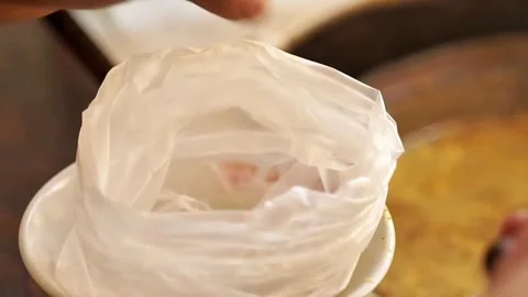 Close up view of wrapping soft goat meat soup in plastic Stock Footage 300620996
