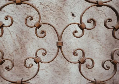 Close-up view of wrought iron design featuring elegant swirls and curves, s.. Stock Photos
