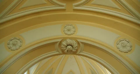Close up view of yellow architectural arches decorated with white floral plaster Stock Footage 344196803