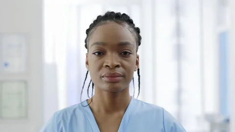 Close up view of young afro-american female doctor looking to camera. Portrait Stock Footage 150625649