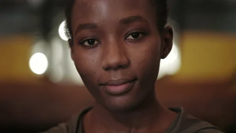Close up view of young afro american woman smiling and looking to camera Video stock 152160255