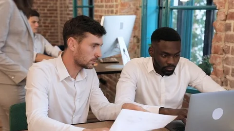 Close up view of Young Afroamerican Working on Computer. Sitting by his Collegue Stock Footage 93712199