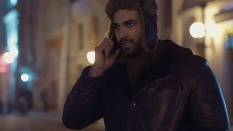 Close up view of young bearded man in a warm leather jacket and fur hat Stock Footage 84652741