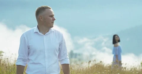 The close-up view of the young blond man turning round and looking at the Stock Footage 82783483