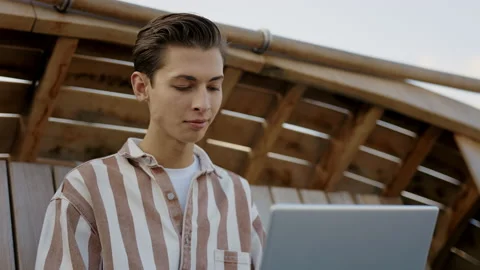 Close View of the Young Caucasian Student is Sitting on the Bench and Studying Stock Footage 237108880