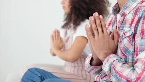 Close view of young couple is meditating and sitting on sofa in apartment room Stock Footage 195081539