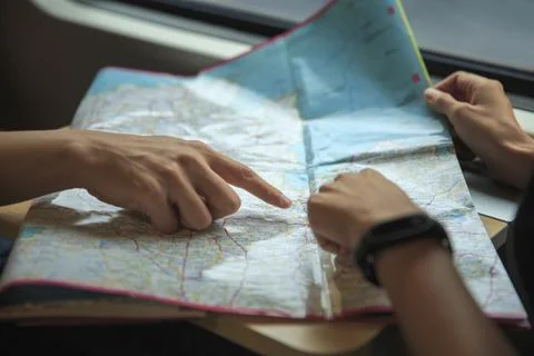 Close up view of young couple planning vacation with the map travel Fotos Stock