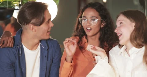 Close up view of young good looking friends laughing and having fun in cafe Stock Footage 139378994