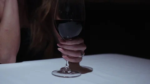 Close up view of young gorgeous brunette woman seductively raising glass of red Stock Footage 112674610