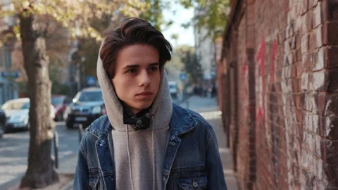 Close up view of young man graffiti artist in balaclava walking near the painted 스톡 동영상 105243372