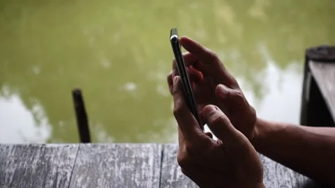 Close-up view of young man playing online with smartphone Video stock 82298734