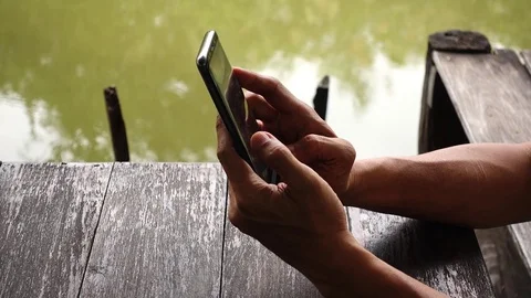 Close-up view of young man playing online with smartphone Video stock 82298887
