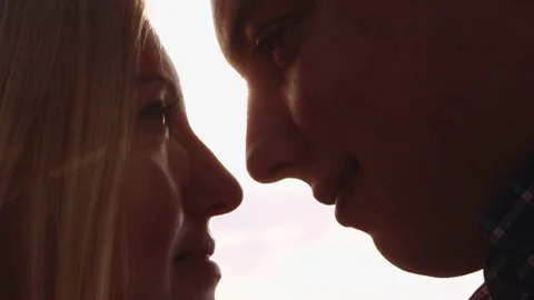 Close up view of young profiles of lovers tenderly looking into the eyes  Video stock 71779441