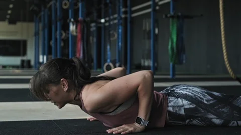 Close-up view of young woman doing push ups and jump exercise Video stock 112302980