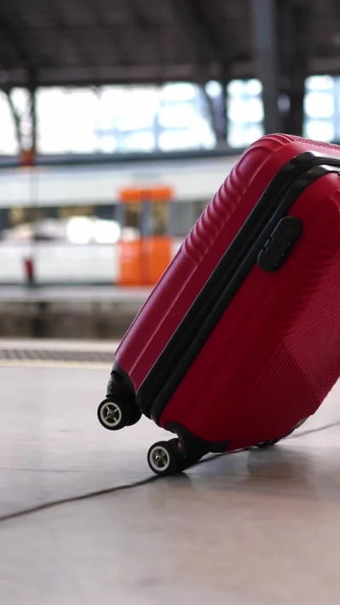 Close-up view of young woman pulling luggage at train station. Stock Footage 302839690