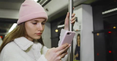 Close up view of young woman using her smartphone while going on public Stock-Footage 137044230