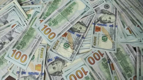 Close-up views of numerous hundred-dollar bills arranged on a surface Stock Footage 346128240