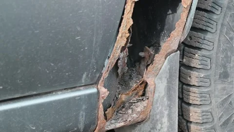 Close-up views show significant rust damage on vehicle body panels. Stockbeeldmateriaal 337550674