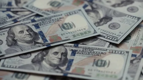 Close-up views of US dollar banknotes stacked together, showcasing intricate Stock Footage 327698820