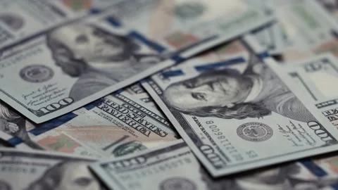 Close-up views of US dollar banknotes stacked together, showcasing intricate Stock Footage 327698884