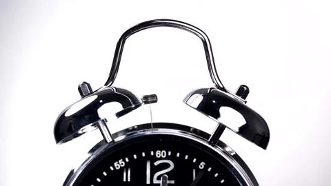 Close-up of vintage alarm clock ringing isolated on white background Stock Footage 143043318