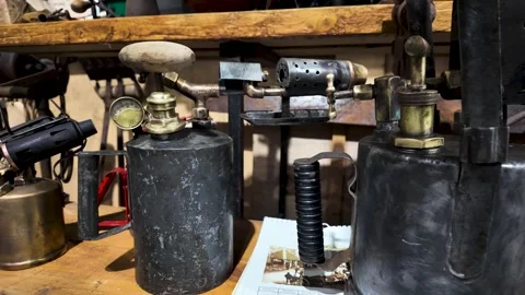 Close Up Of Vintage Blow Torches On A Workbench, Highlighting Industrial History Vídeo Stock 339378540